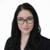 a woman with long black hair wearing glasses