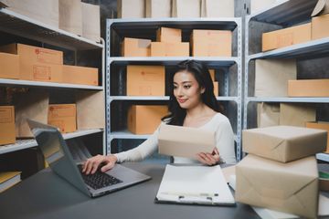 A woman sitting at a desk working on a laptop