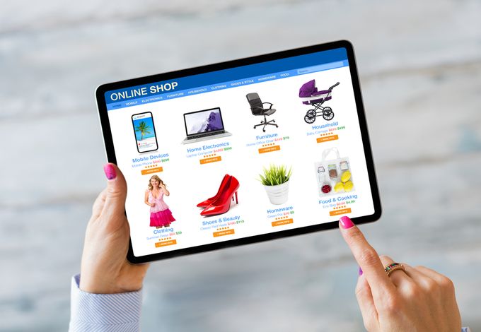 a woman is holding a tablet while browsing an online shop's products