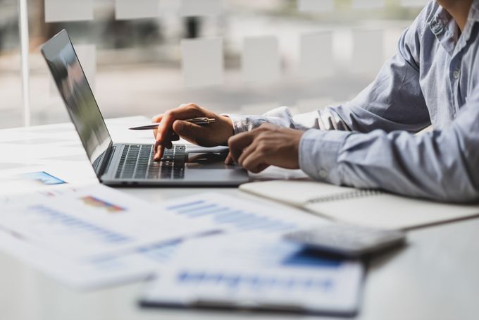 A man looking at information on his laptop