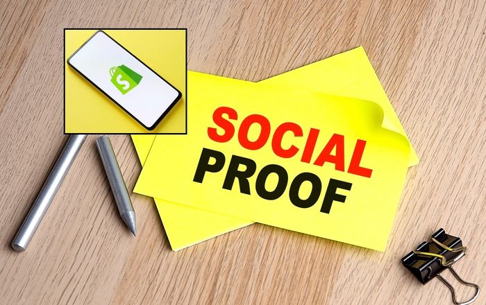Yellow note reading "Social Proof" with a phone displaying the Shopify logo