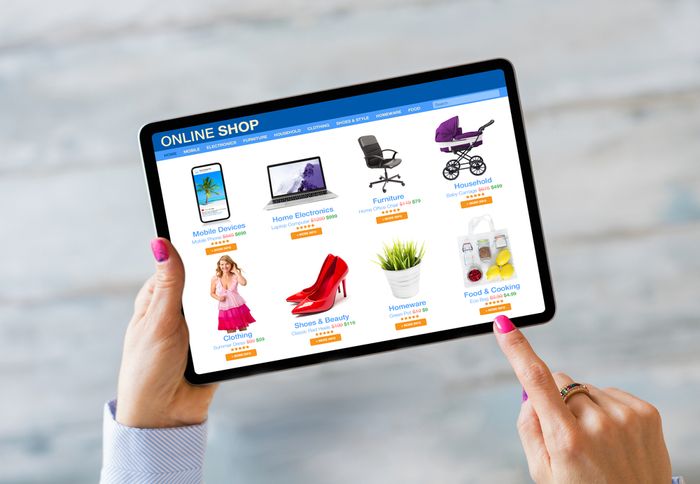 a woman is holding a tablet while browsing an online shop's products