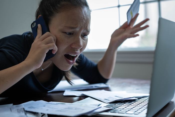 An exasperated woman arguing on the phone over financials 